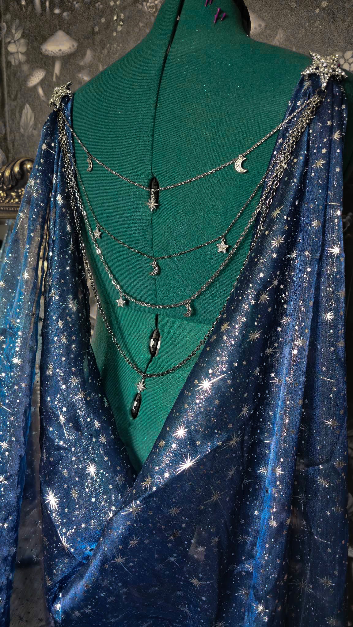 Beautiful celestial cape with a jewelry statement back piece.